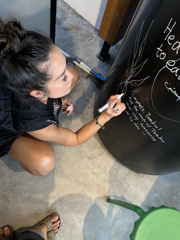 Guest signing the chalkboard wall at Batu Bolong