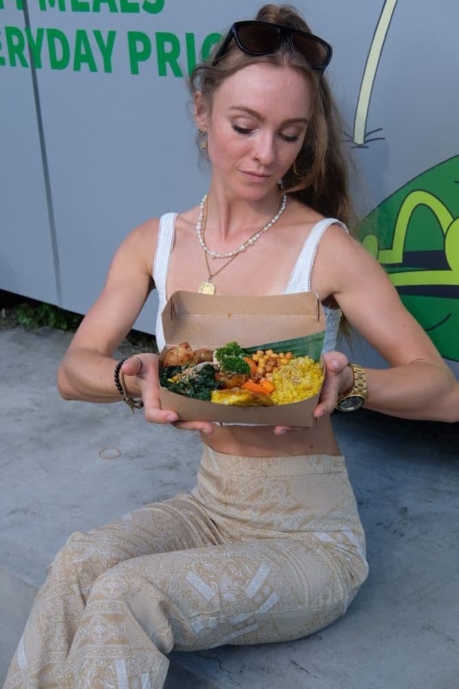 Guest outside the store with an open meal box
